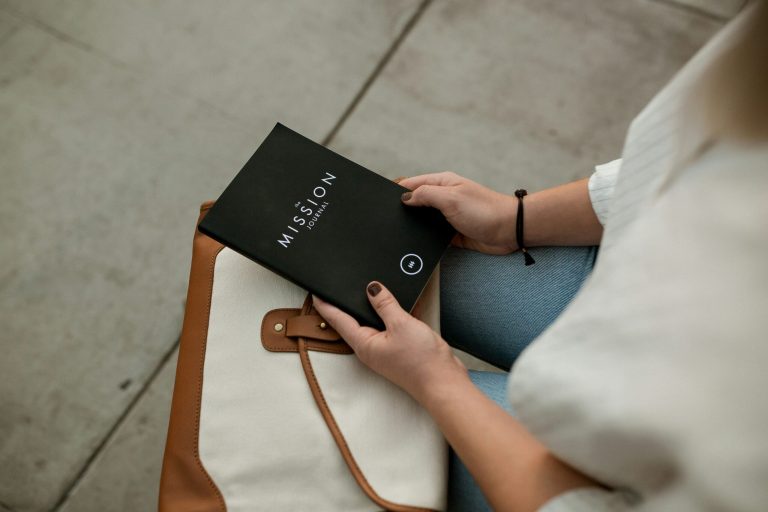 woman holding black Mission book scaled 1